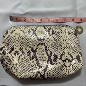 Estée Lauder cream and purple cosmetic bag
